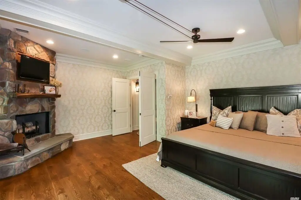 bedroom with stone fireplace
